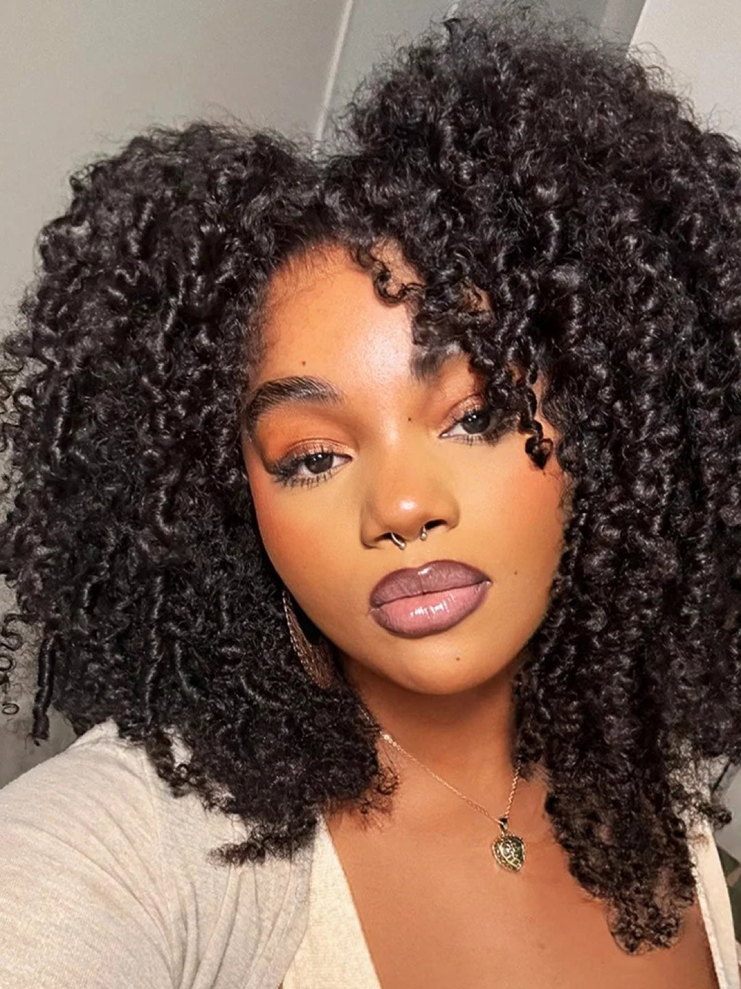 Woman wearing a full natural black Afro Kinky Curly hairstyle
